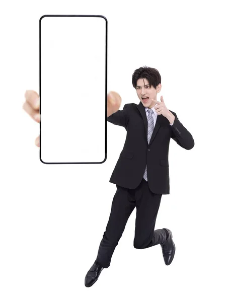 Jovem Homem Negócios Pulando Mostrando Tela Telefone Celular Branco — Fotografia de Stock