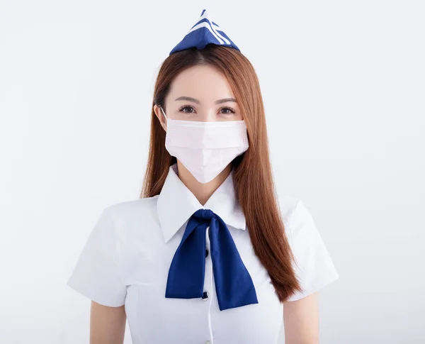 若いです女性航空ホステスで制服とともにホワイトマスク — ストック写真