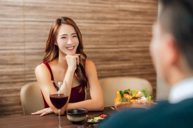 Happy young couple having romantic dinner at restaurant.