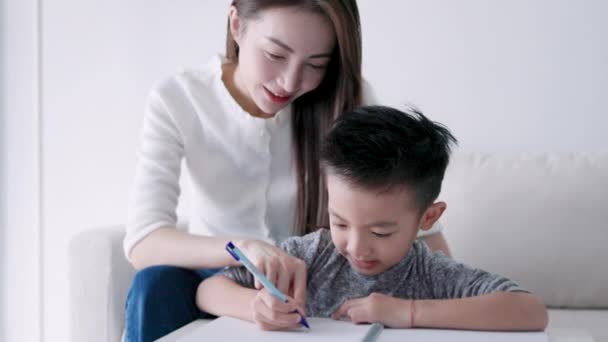 Young Mother Checking Homework Helping Child Study Home — Αρχείο Βίντεο
