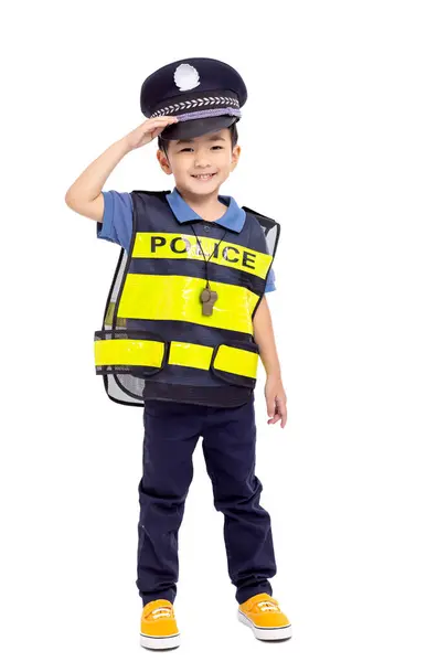 白い背景の前に立っている警察官の格好をした子供 ストック写真