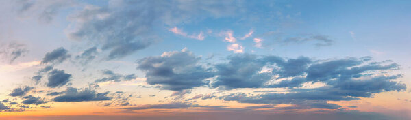 Extra wide panorama of the sunset sky. Light colored clouds. No birds in the sky. Sunrise Sundown Sunset sky panoramic image