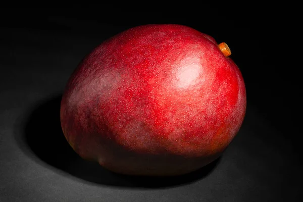 red mango on black background