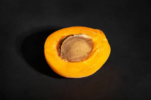 stock image sliced apricot on black background