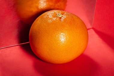 kırmızı arkaplanda aynalı greyfurt