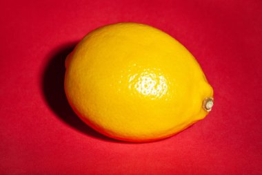 Kırmızı arkaplanda tek limon