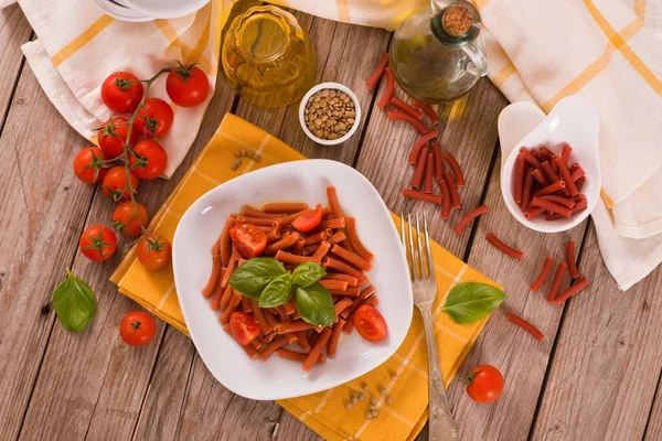 Lentil pasta with cherry tomatoes and basil.