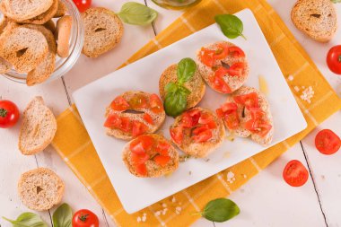 Friselle with cherry tomatoes and basil.