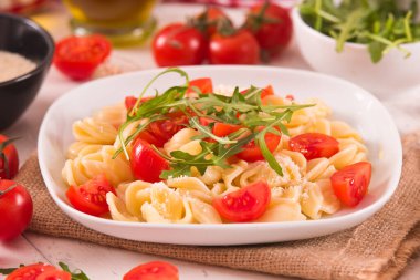 Orecchiette pasta with arugula and tomato.