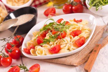 Orecchiette pasta with arugula and tomato.