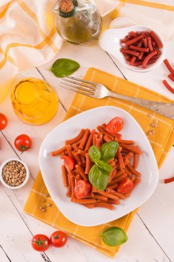 Lentil pasta with cherry tomatoes and basil.