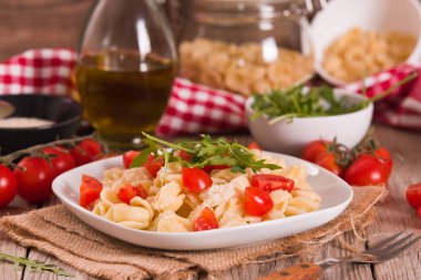 Orecchiette pasta with arugula and tomato.