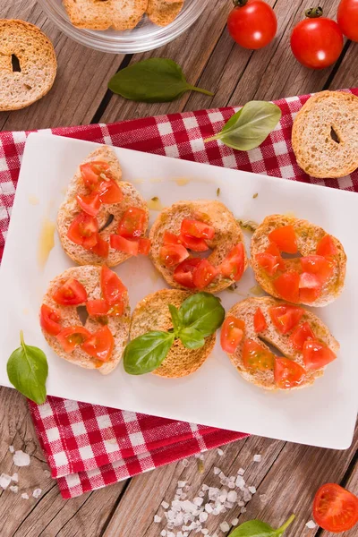 stock image Friselle with cherry tomatoes and basil. 