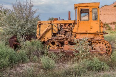 Abandoned yellow bulldozer in a quarry