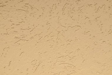 Surface puttied with decorative putty as a background. Preparation of facade walls