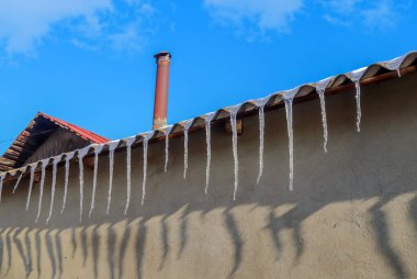 ice icicles hanging from the roof