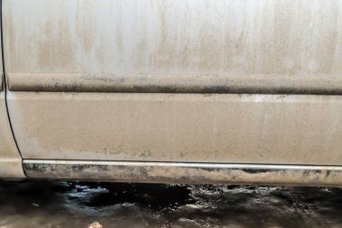 Dirty car in autumn close-up.