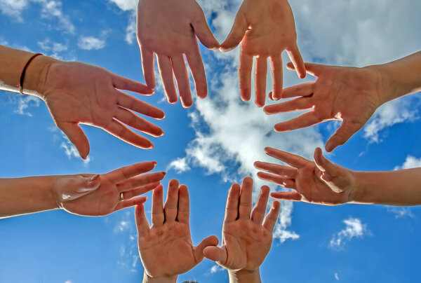 Sky with clouds and hands against the sky