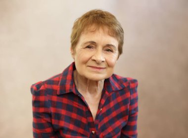 woman headshot in her 70s studio background