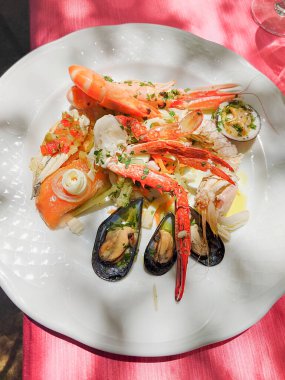 Restoranda Akdeniz balığı atıştırması. Bir İtalyan restoranında taze balık tabağı. Kabuklular ve yumuşakçalar