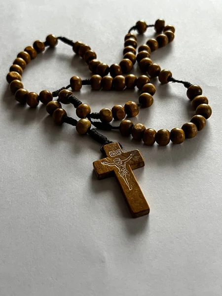 stock image wooden rosary lying on a white sheet of paper