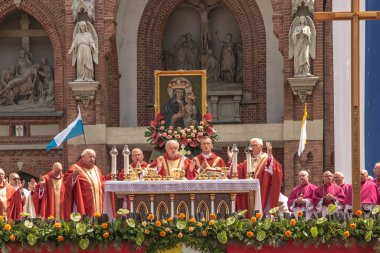 Piekary Slaskie, Poland, May 28, 2023: Pilgrimage of men and young men to Mary Piekarska. Coadjutor Archbishop of Katowice Adrian Galbas blesses and high-fives children. clipart