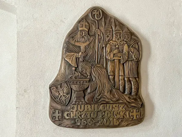 stock image Tum, Poland, April 12, 2024: Fragment of the interior of the 12th-century collegiate church in Tum. Commemorative plaque in the church vestibule - Baptism of Poland.