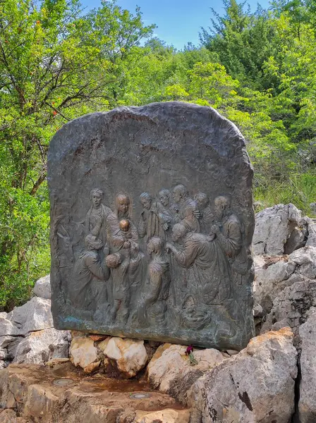 stock image Podbrdo, Bosnia, June 10, 2024: Relief representing the joyful mysteries of the Rosary on Mount Podbrdo, the Apparition hill overlooking the village of Medjugorje in Bosnia. The birth of Jesus.