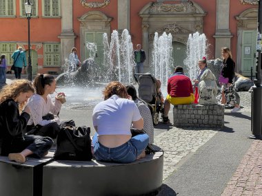 Gdansk, Polonya, 12 Mayıs 2024: Eski Gdansk kasabası, Polonya. Tarihi binalar, kafeler, dükkanlar ve aylakların dinlenip dinlenebileceği yerler. Ancak, insanlar bazen akıllı telefonlarına bakarlar..