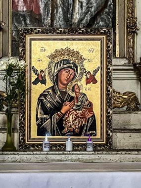 Chelmno, Poland, May 6, 2024: The parish church of the Assumption of the Blessed Virgin Mary in Chelmno. One of the side altars, with an icon of Mary. clipart