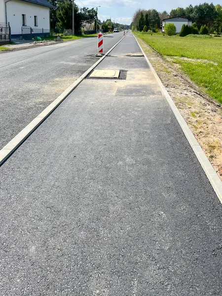 stock image The street and sidewalk prepared for the final, final layer of asphalt.