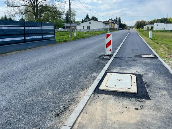 stock image The street and sidewalk prepared for the final, final layer of asphalt.