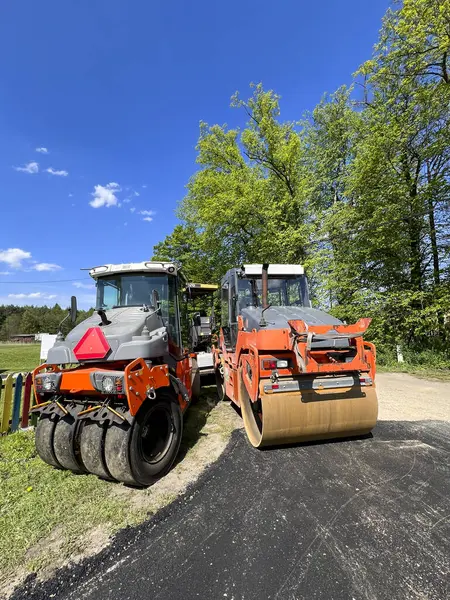 stock image Road rollers left on the side of a road under construction.