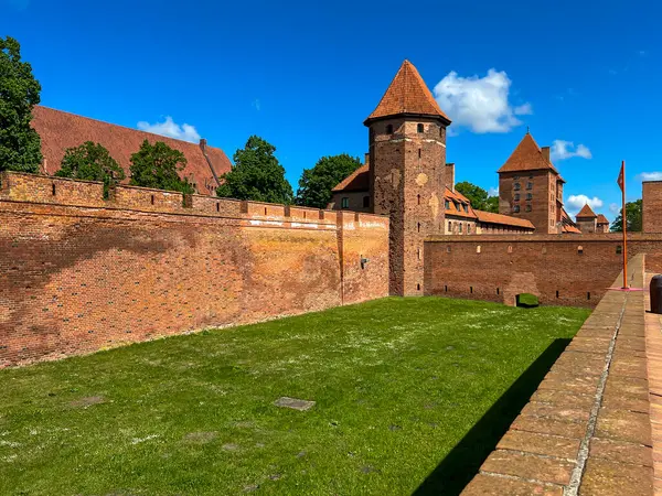 stock image The Castle of the Teutonic Order in Malbork in Poland, commonly known as Malbork Castle. Figure of Mary on the outer wall of the castle chapel.