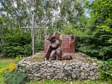 Siedlec, Poland, July 23, 2024: Sanctuary of Saint Padre Pio - a sanctuary located on Przeprosna Gorka in Siedlec. The Way of the Cross with Padre Pio, Station 3. The first fall of Jesus under the cross. clipart