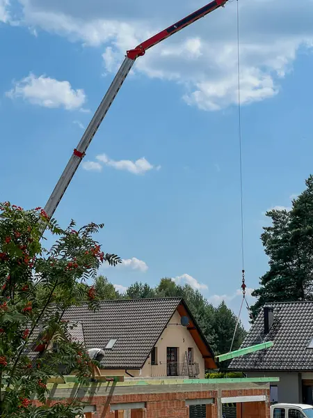 stock image Building a roof truss of a single-family house using a small crane.