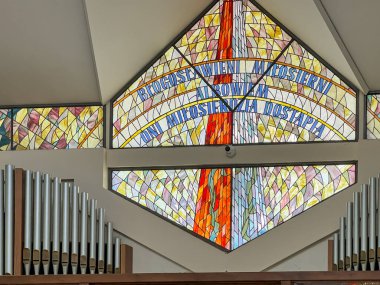 Siedlec, Poland, July 23, 2024: Sanctuary of Saint Padre Pio - a sanctuary located on Przeprosna Gorka in Siedlec near Czestochowa in Poland. Polish San Giovanni Rotondo. Stained glass above the entrance to the upper church. clipart