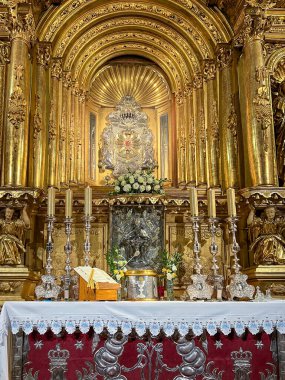 Gidle, Poland, July 23, 2024: Basilica of the Assumption of the Blessed Virgin Mary in Gidle, Poland. Early Baroque interior, altar in the side chapel with a tiny miraculous figure of Mary with Jesus. clipart