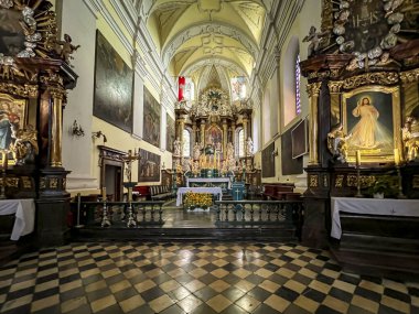 Gidle, Poland, July 23, 2024: Basilica of the Assumption of the Blessed Virgin Mary in Gidle, Poland. Early Baroque interior, main nave and altar. clipart