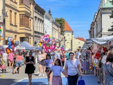 Nowy Sacz, Poland, August 7, 2024: Indulgence in the Church of the Transfiguration of the Lord in Nowy Sacz. Street and stall sales of various toys, souvenirs and sweets. clipart