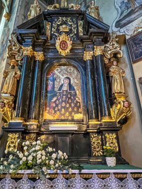 Stary Sacz, Poland, August 4, 2024: Interior of the Church of the Holy Trinity and Saint Clara in Stary Sacz - Side altar, St. Kinga.