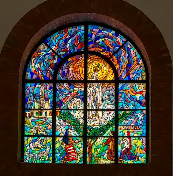 stock image Nowy Sacz, Poland, August 7, 2024: Sanctuary of St. Rita in Nowy Sacz, Poland. Interior, stained glass window depicting the apparition of Mary in Fatima.