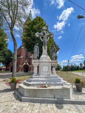 Old cross in front of the church of the Nativity of the Blessed Virgin Mary in Gliwice Bojkow, Poland. clipart