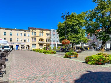 Lubliniec, Poland, August 13, 2024: The Market Square in Lubliniec with the figure of St. Teresa Benedicta of the Cross as a child, because she used to visit her family there as a child. clipart