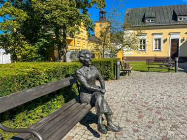 Koszecin, Poland, August 17, 2024: Bench with a sculpture of Elwira Kaminska, co-founder of the 