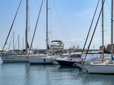 Paphos, Cyprus, October 13, 2024: The port of Paphos, Cyprus. The port quay with moored yachts, small ships and various port equipment. clipart