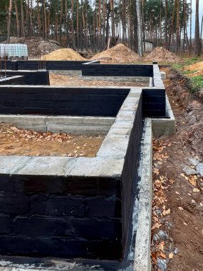 Beton bloklardan yapılmış, çelik çubuklarla güçlendirilmiş, hamile bırakılmış beton zemindeki tek bir aile evinin izolasyonu..