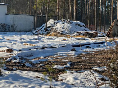 Kışın ağaçların arasında, karla kaplı tamamlanmış tek bir aile inşaat sahası..