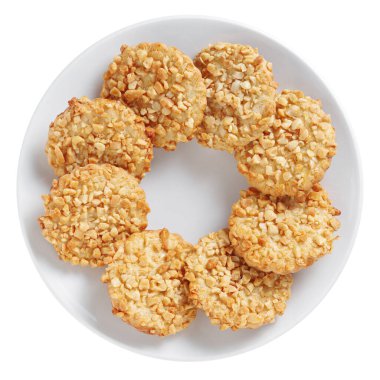 Biscuits with peanuts on a plate isolated on white background, top view 