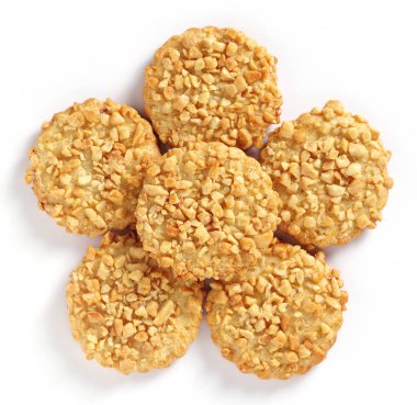 Biscuits with peanuts on white background close-up, top view